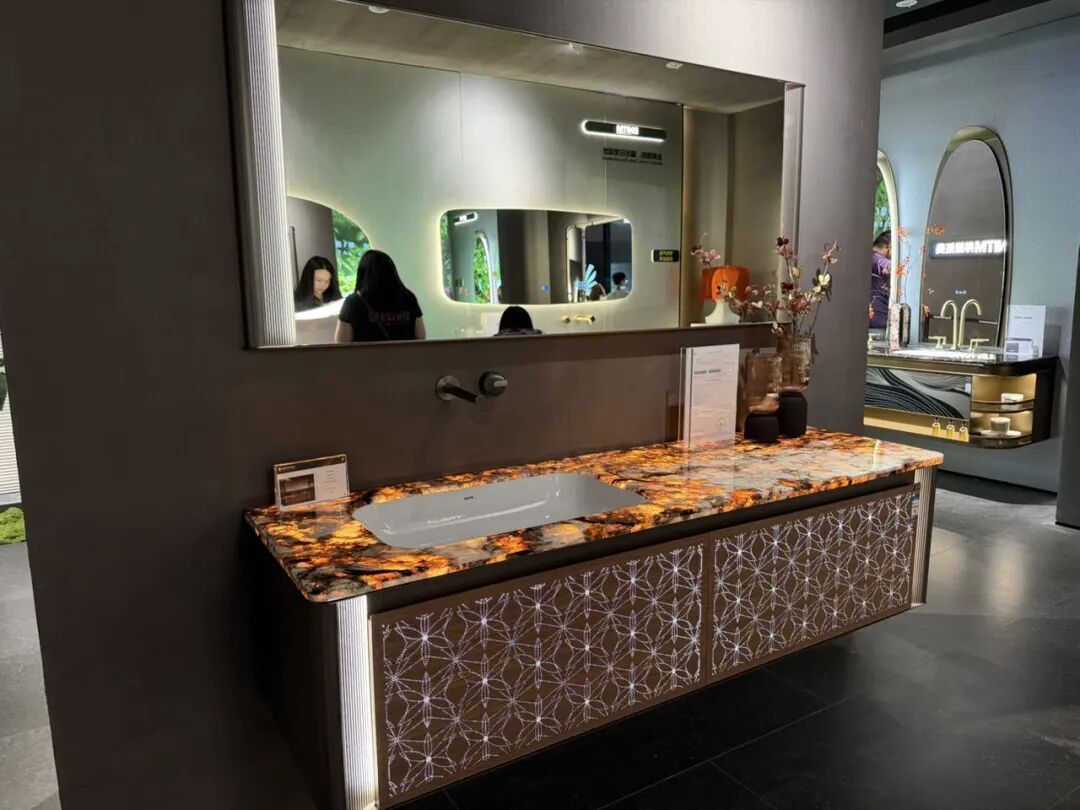 Modern bathroom vanity with wood-grain cabinet, white countertop sink, and round mirror at 2026 Shanghai KBC Expo